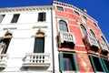 Two different buildings, one red seen from the Grand Canal in Venice in Italy Royalty Free Stock Photo