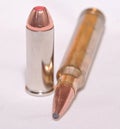 Two different bullets, a .300 Winchester Magnum for a rifle and a .44 special for a handgun Royalty Free Stock Photo