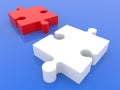 Two different colored puzzle pieces on blue Royalty Free Stock Photo