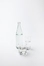 two different glasses and bottle with calm water Royalty Free Stock Photo