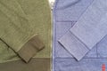 Two different hoodies, green and blue, connected by a single zip. Creative idea. Copy space. Top view. Royalty Free Stock Photo