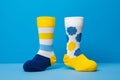 Two different mismatched socks on light blue background. Odd Socks Day, Lonely Sock Day, Anti-Bullying Week, Down Royalty Free Stock Photo