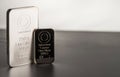 Two different silver minted bars on a gray background. Royalty Free Stock Photo