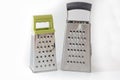 Two different sized graters for vegetables on a bloom background, Royalty Free Stock Photo