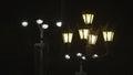 Two different street lanterns on black sky background. Stock footage. Old fashioned and modern street lamps with yellow Royalty Free Stock Photo