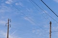 Two different types of utility poles, one modern and one older Royalty Free Stock Photo
