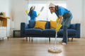 Two diligent Asian maids collaborate seamlessly, cleaning the living room with precision and efficiency, leaving no corner