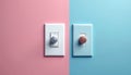 Two dimmers with rotary knobs stand on a split pink and blue background. One dimmer has a silver knob, the other a copper knob. Royalty Free Stock Photo