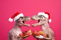 Two dinosaurs Rex in red Santa Claus hat holds golden gift box in its paws on pink background New Years Eve or Christmas Eve Art h Royalty Free Stock Photo