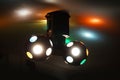 Two disco balls rotating on a ceiling, colorful lights