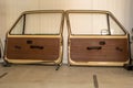 2 dismantled doors from an old car stand on a wall in a workshop Royalty Free Stock Photo