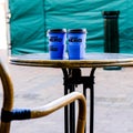 Two Disposable Blue Caffe Nero Disposable Cups On A Table Top