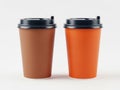 Two disposable coffee cups with black lids on a white surface isolated on white background Royalty Free Stock Photo