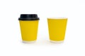 Two disposable yellow cardboard coffee cups on a white background