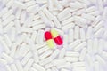 Two dissimilar capsules lie on white capsules Royalty Free Stock Photo