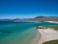 Two distant people on a white sand beach in Luskentyre Bay on the coast of the Isle of Harris, Outer Hebrides, Scotland, UK. Royalty Free Stock Photo