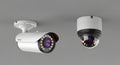 Two Modern Security Surveillance Cameras Mounted on a Gray Ceiling CCTV dome Royalty Free Stock Photo