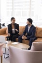 Two diverse business professional couple talking in office hall Royalty Free Stock Photo