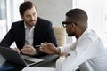 Two diverse businessmen negotiating in modern office during meeting