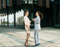 Two diverse businesswomen. Excited afro female sharing ideas or startup business plan with blond woman. Royalty Free Stock Photo