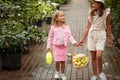 Two diverse kid girls with basket full of lemons