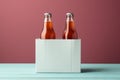 Two diverse nonalcoholic soda bottles with a white paper box on a Toscha background