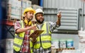 Two diverse professional male workers holding board, checking shipping stocks in storage, warehouse or factory for delivery,