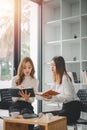 Two diverse serious businesswomen discussing business project working together in office, Royalty Free Stock Photo