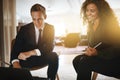 Two smiling diverse businesspeople working together in an office Royalty Free Stock Photo