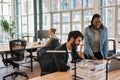 Two diverse young businesspeople smiling while working together on a laptop Royalty Free Stock Photo