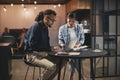 Two diverse young businesspeople working together at an office t Royalty Free Stock Photo