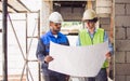 Two diversity male engineers team working, inspecting outdoor at construction site, wearing hard hats for safety, talking, Royalty Free Stock Photo