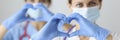 Two doctor in medical masks and rubber gloves showing heart with their hands Royalty Free Stock Photo