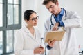 Two doctors checking together the medical record of a patient