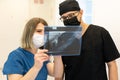 Two doctors checking x-ray image in hospital, high quality photo