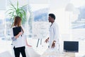 Two doctors communicate at the conference room in the hospital. African male and caucasian female medical students at Royalty Free Stock Photo