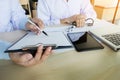 Two doctors discussing patient notes in an office pointing to a Royalty Free Stock Photo