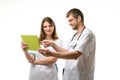 Two doctors discussing the patient\'s tests while looking at the tablet computer screen Royalty Free Stock Photo