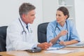 Two doctors discussing and working together Royalty Free Stock Photo