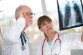 Two doctors examining x-ray report Royalty Free Stock Photo