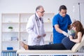 Two doctors examining young woman Royalty Free Stock Photo