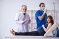 Two doctors examining young woman Royalty Free Stock Photo