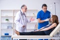 Two doctors examining young woman Royalty Free Stock Photo