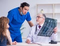 Two doctors examining young woman Royalty Free Stock Photo