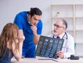 Two doctors examining young woman Royalty Free Stock Photo