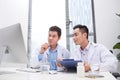 Two doctors holding and talking about patient on office Royalty Free Stock Photo