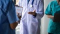 Two doctors stand in a conference room discussing, brainstorming on how to plan a patient's treatment in a complex case that Royalty Free Stock Photo