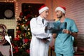 Two doctors work on New Year`s Eve and discuss an X-ray that is held in hands. Royalty Free Stock Photo