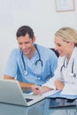 Two doctors working together on a laptop Royalty Free Stock Photo