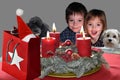 Waiting for christmas, dogs and children behind a table with advend wreath Royalty Free Stock Photo